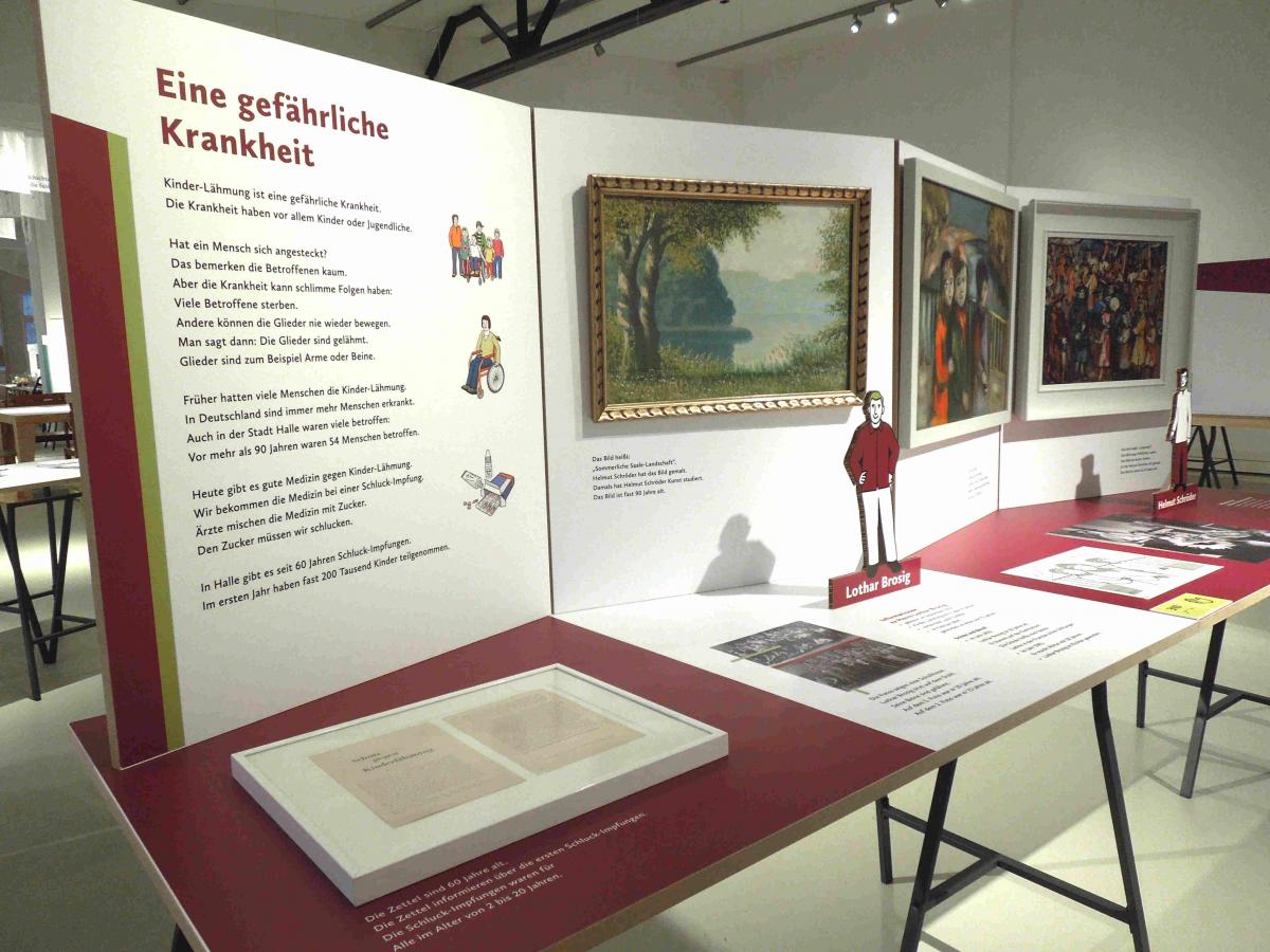 Ausstellungstisch mit Dokumenten, Figuren und Gemälden