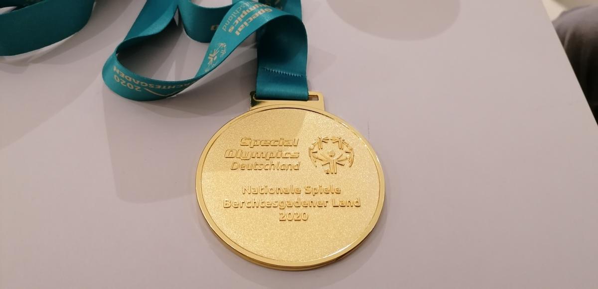 Goldmedaille der Special-Olympics an einem grünen Band